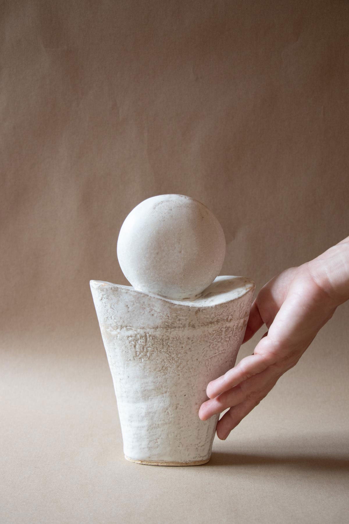 White ceramic sculpture inspired by the Full Moon. Contemporary ceramic sculpture. Yoga studio decor. Full Moon. Handmade ceramics made in Italy. Claire Lune.