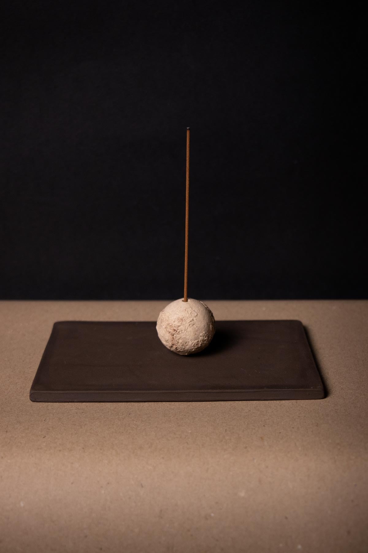 artistic ceramic incense burner. Organic sphere on a rectangular brown tray. wabi sabi décor