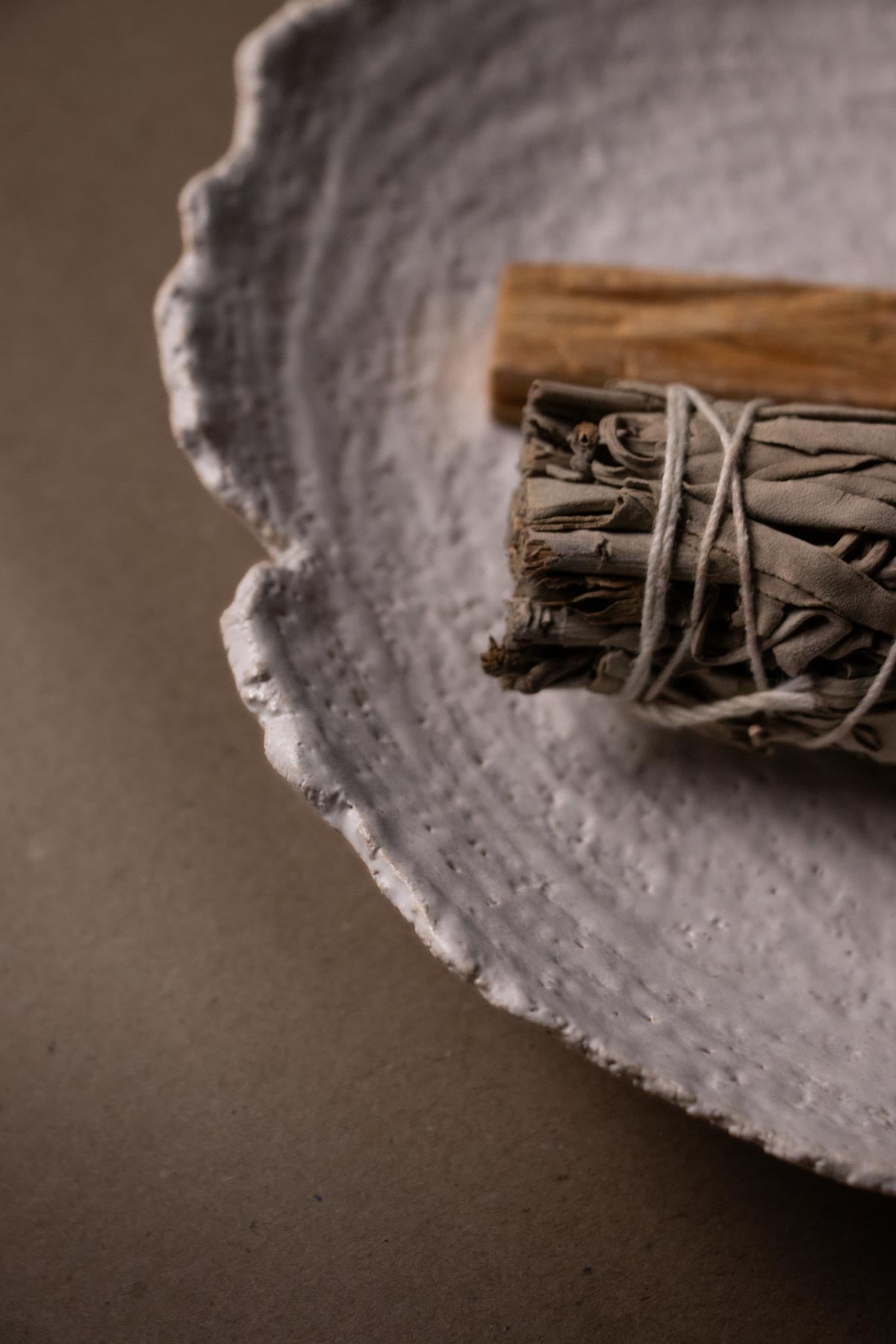 Close-up of textured rim of ceramic plate. Ritual dish.