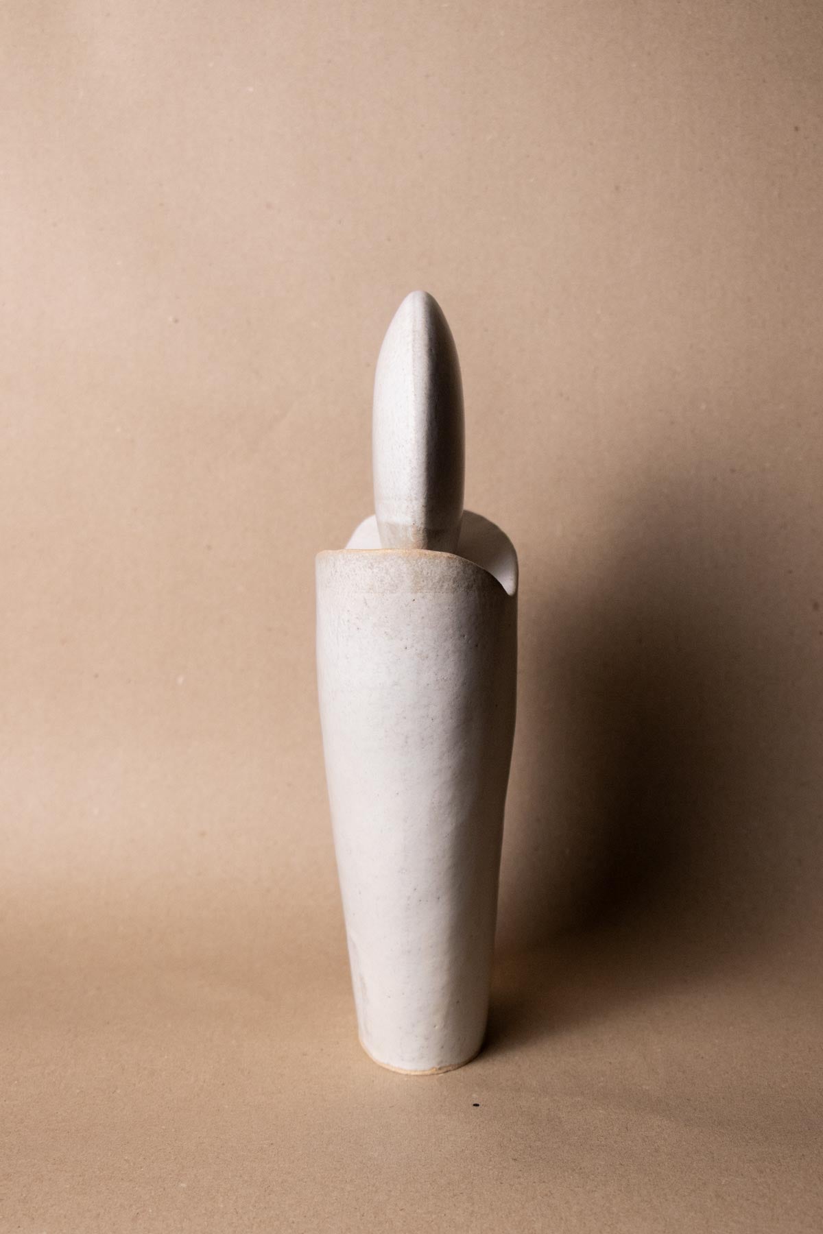 side view of white ceramic sculpture inspired by the Full Moon. Contemporary ceramic sculpture. Yoga studio decor. Full Moon. Handmade ceramics made in Italy. Claire Lune.
