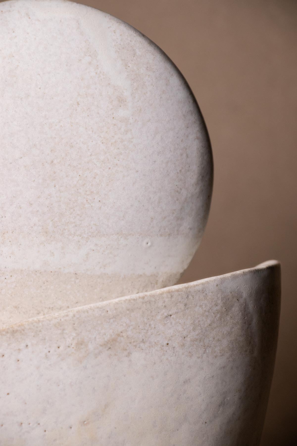 Close-up of moon inspired ceramic sculpture. Contemporary ceramics. Handmade ceramics. Interior decor objects.