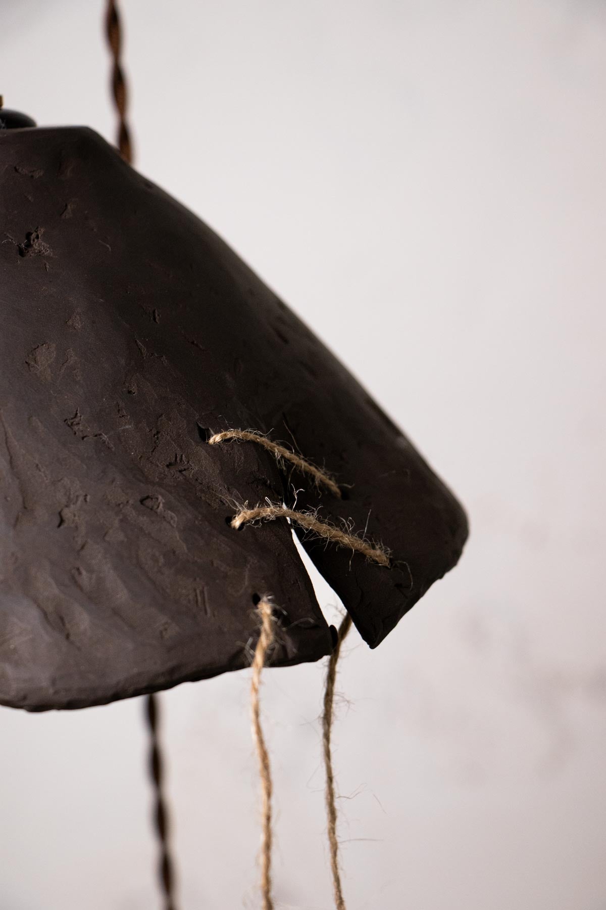 Close-up of a wabisabi lamp. Ceramic lamp. Handmade ceramics. One of a kind pendant lamp. Design lamp. Minimalist interior.