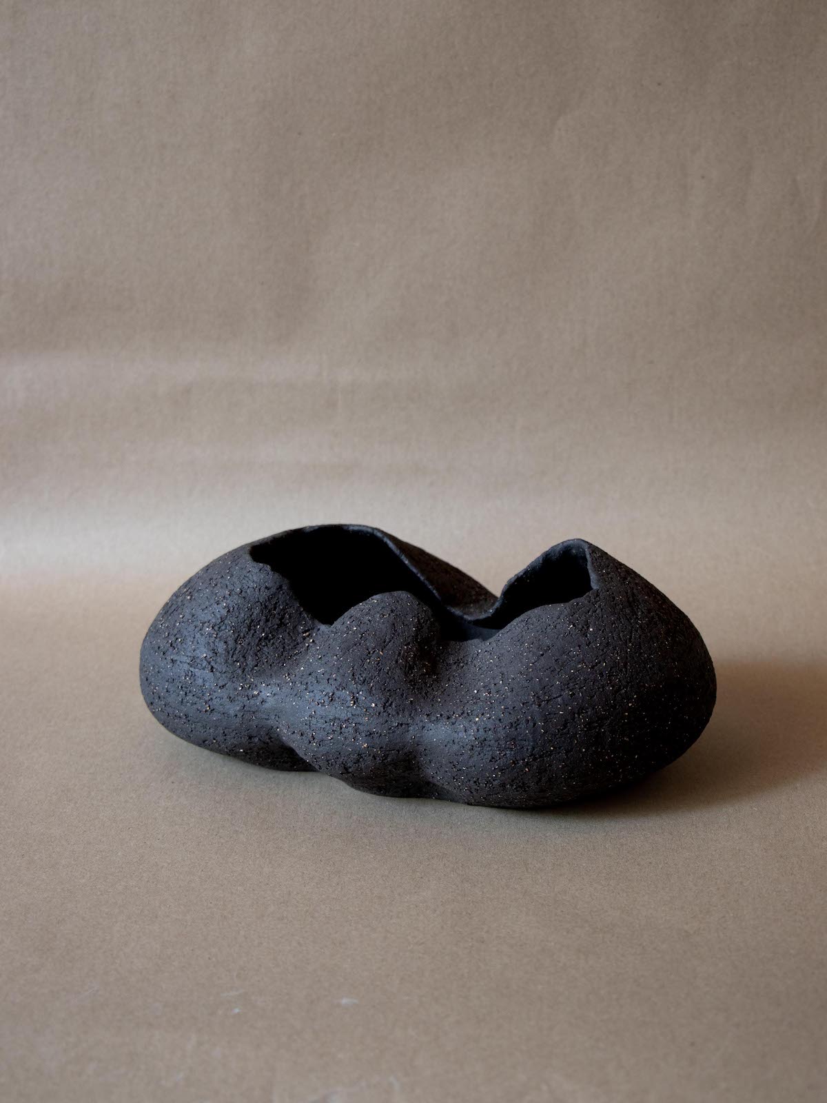 Contemporary black ceramic sculpture. Abstract shape. Table and shelf decor.