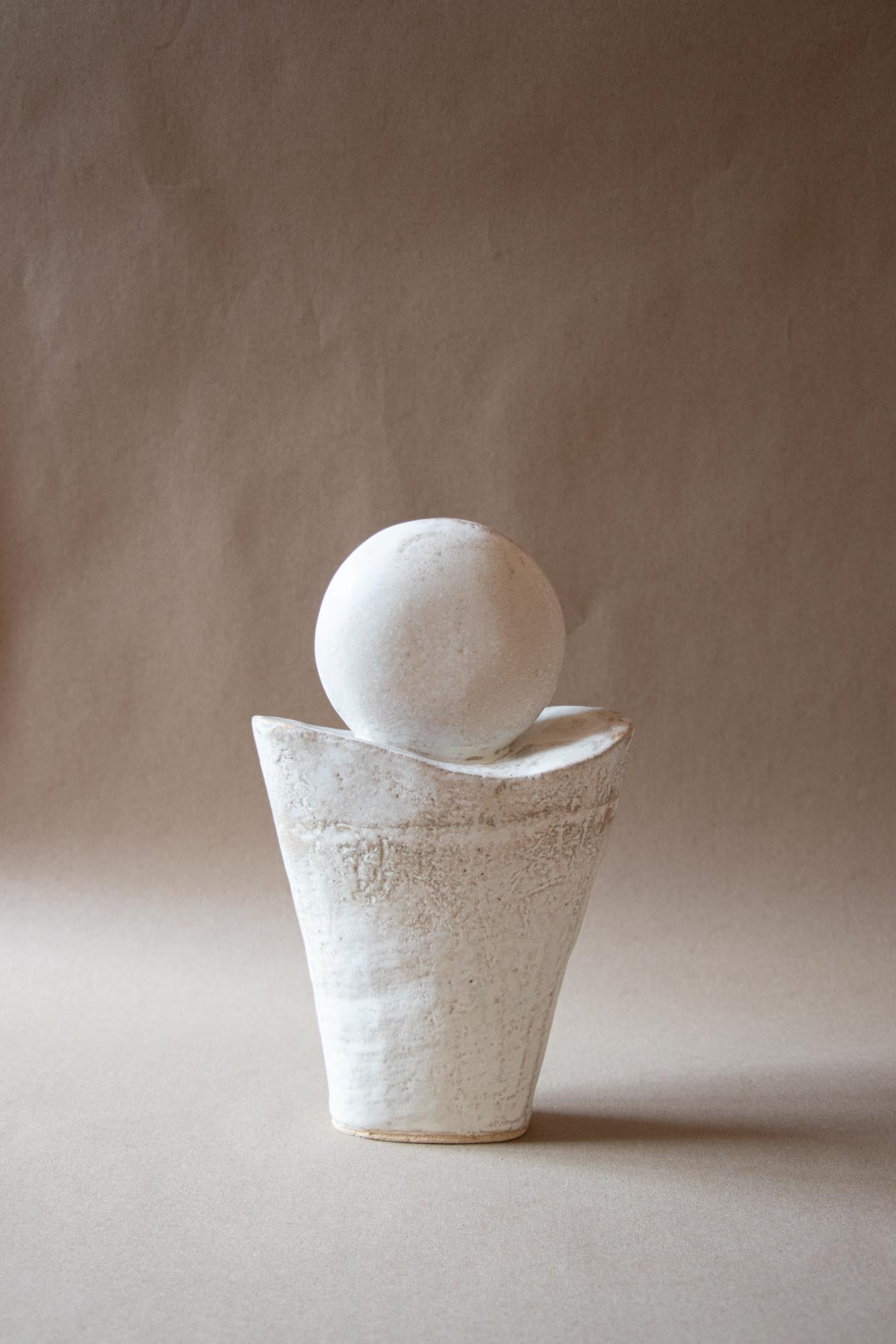 White ceramic sculpture inspired by the Full Moon. Contemporary ceramic sculpture. Yoga studio decor. Full Moon. Handmade ceramics made in Italy. Claire Lune.