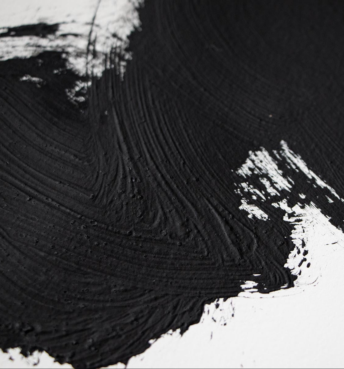 Black brushstroke on white paper