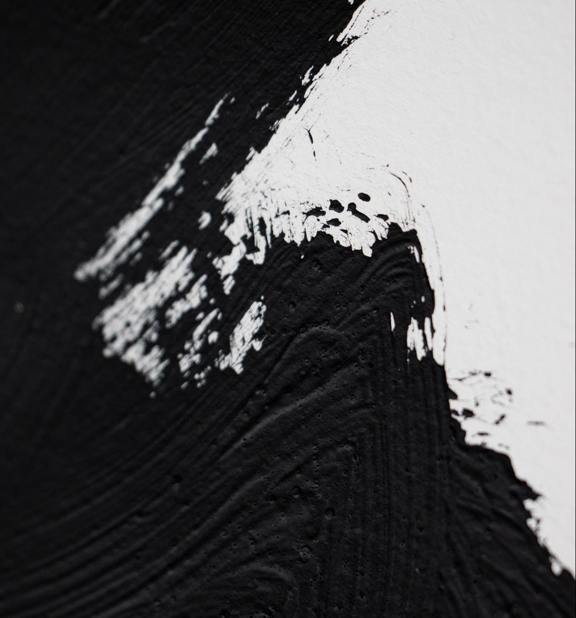 Black brush stroke on white paper