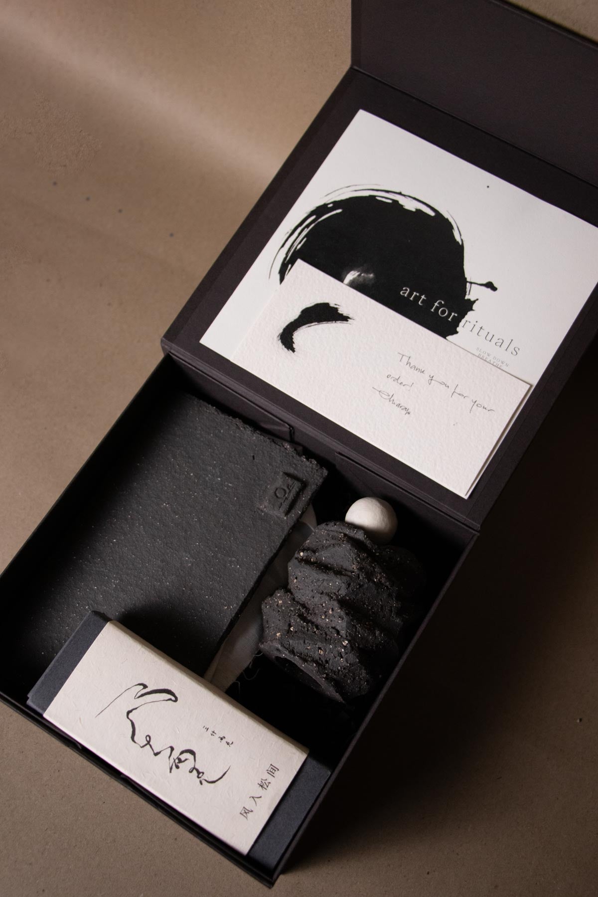 Ritual kit by Claire Lune containing a ceramic incense burner inspired by the moon. Sanshiliangke incense box. ink artworks. Ink brushstrokes 