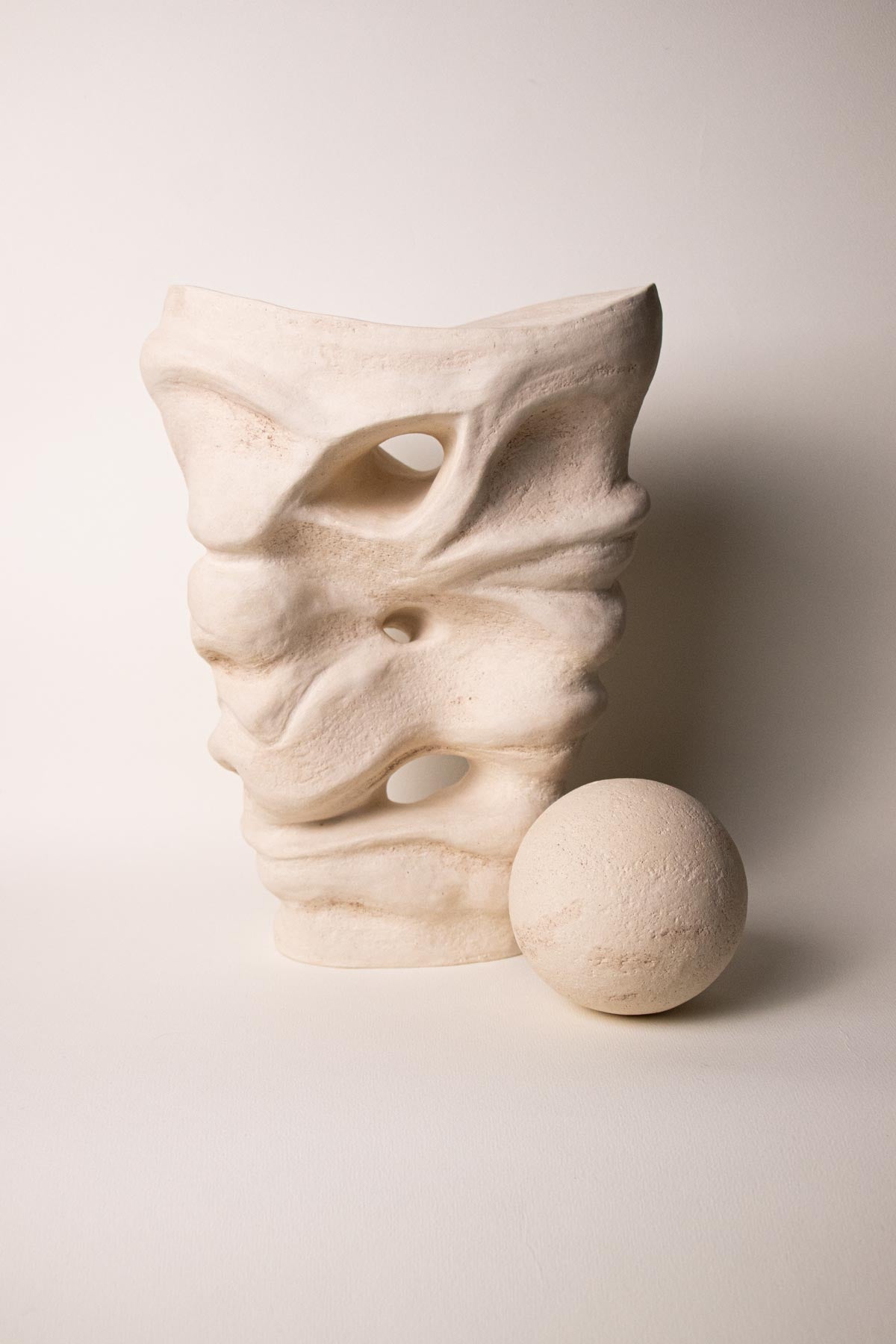 Abstract contemporary ceramic sculpture. Off-white, cream colour. White stoneware. Handmade ceramic sculpture. Handmade Italian ceramics. 
