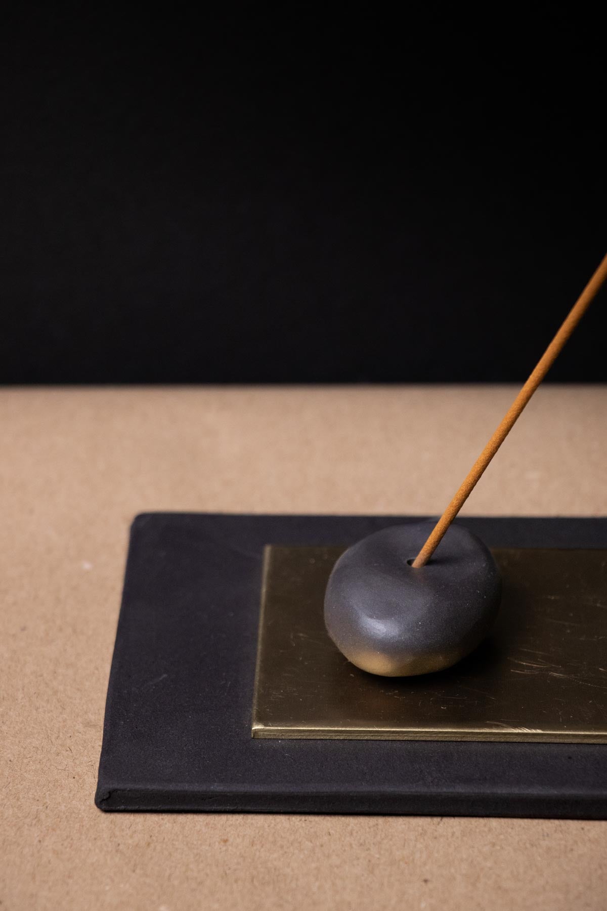 Close-up of a black and brass incense burner. 