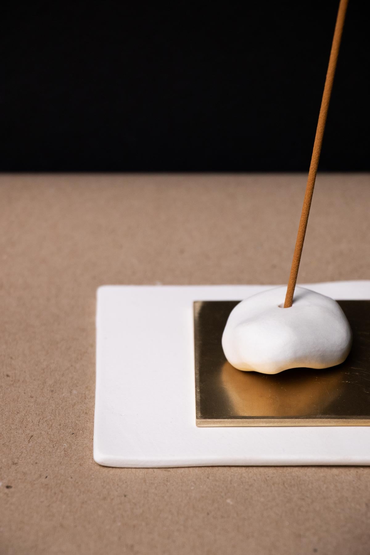 Close-up of a ceramic and brass incense holder. Luxury incense burner. Handmade ceramics. Contemporary ceramics. 
