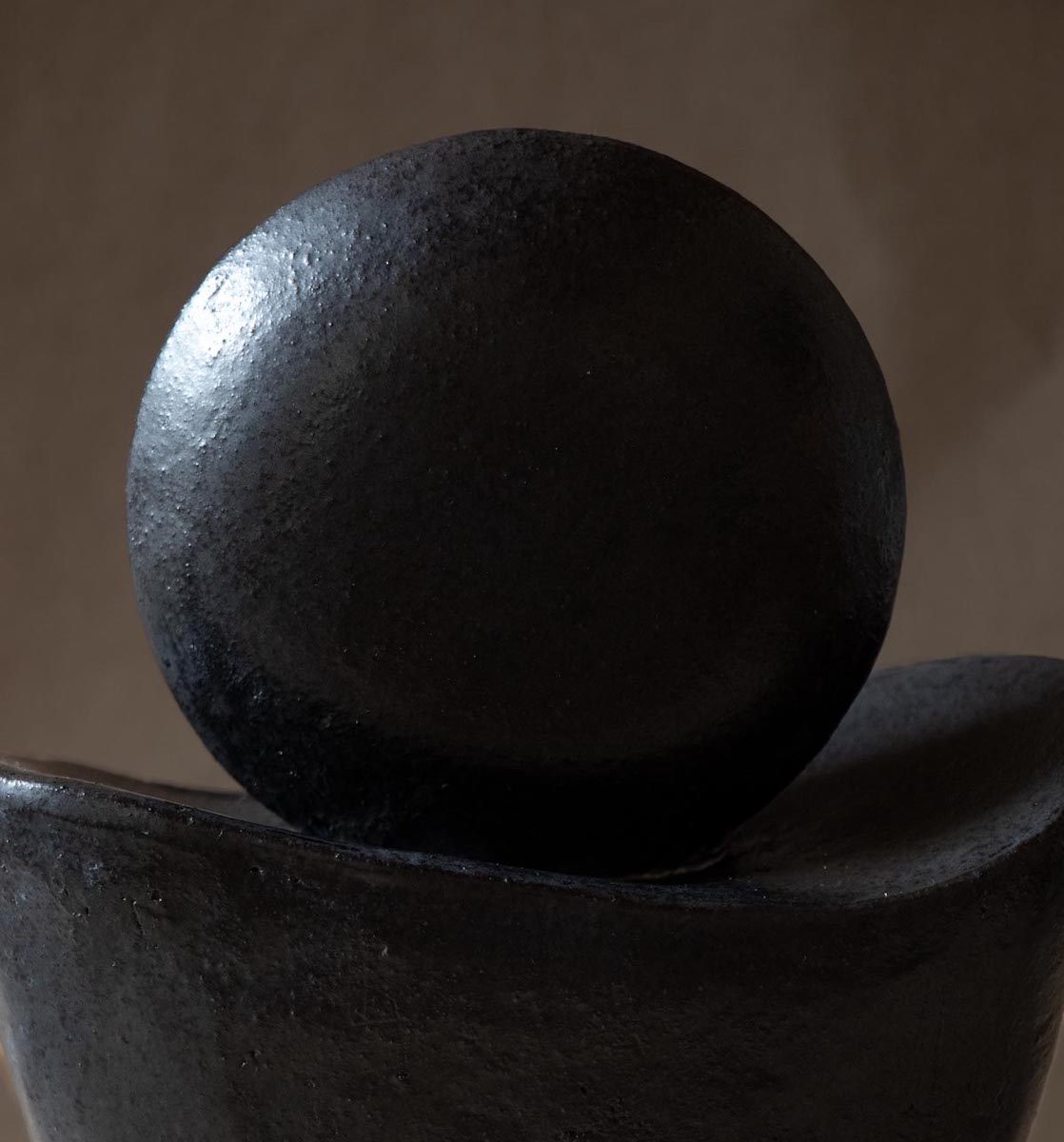 Black ceramic sculpture inspired by the new moon