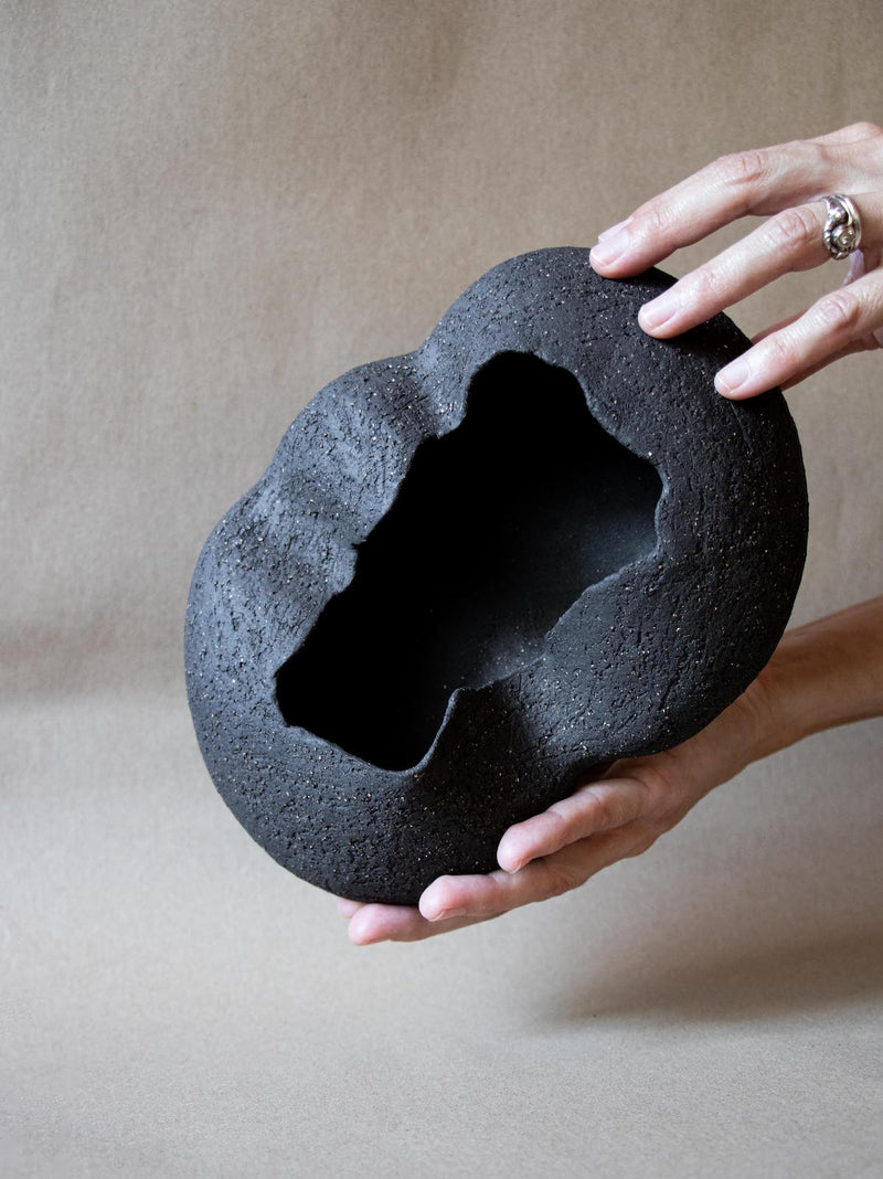 Contemporary black ceramic sculpture. Abstract shape. Table and shelf decor.