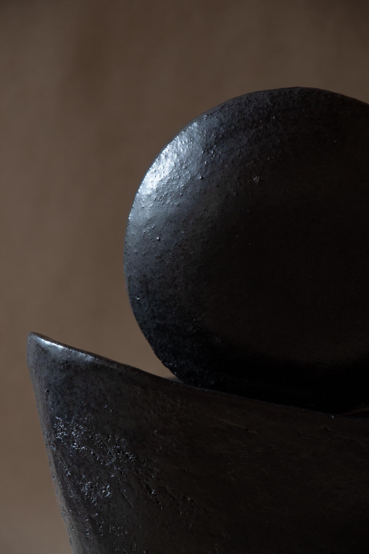 Black ceramic sculpture inspired by the New Moon. New Moon sculpture. Yoga studio decor. Meditation room decor. handmade ceramics by Claire Lune.